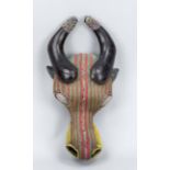 Cow mask, probably West Africa, probably 20th century, dark wood set with colorful beads, slightly