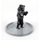 Anonymous sculptor, c. 1920, standing bear, dark patinated bronze in a shallow gray marble bowl,