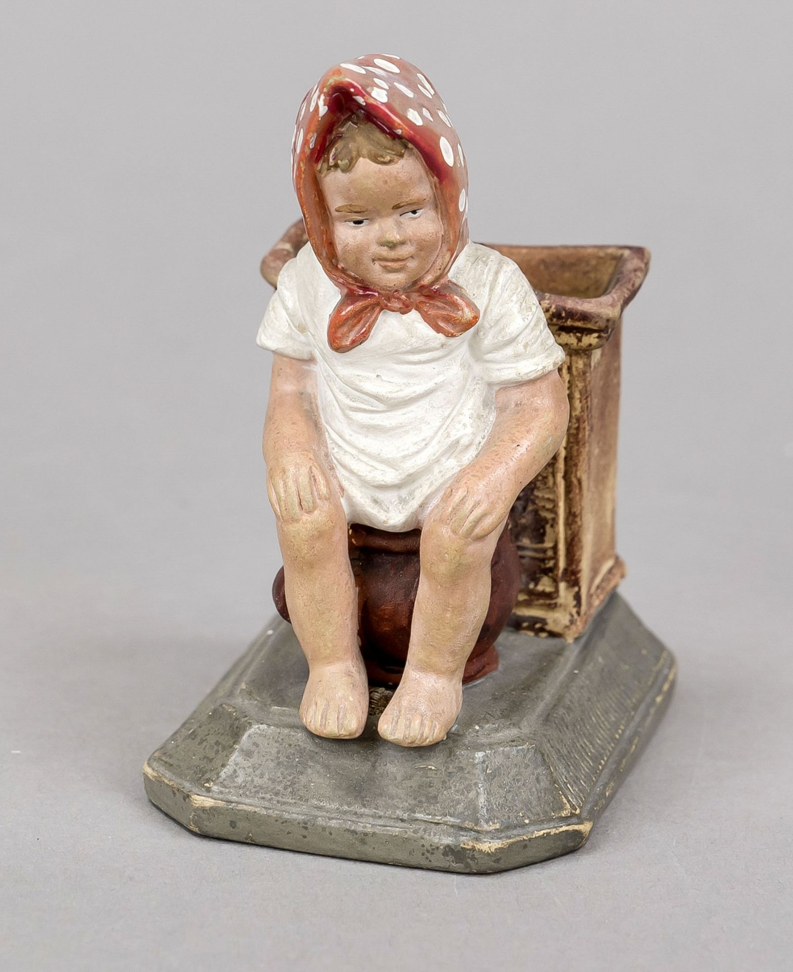 Humorous match holder, late 19th century, polychrome painted stoneware. Girl on a chamber pot in