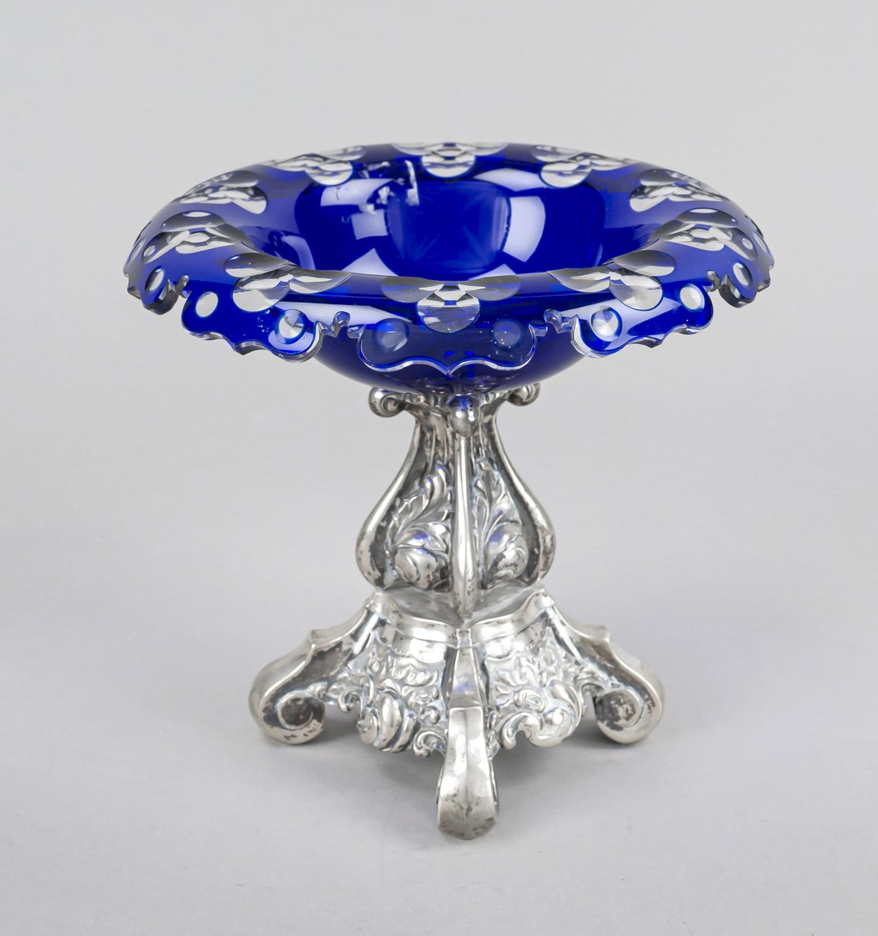 Centerpiece, late 19th century, filled stand, probably under-alloyed silver, square form on 4 volute