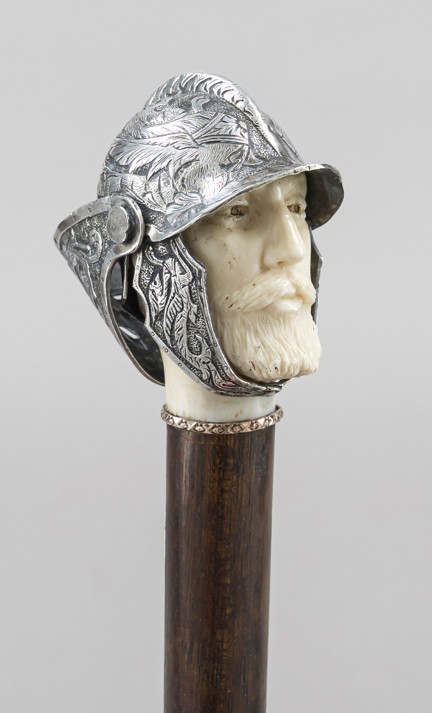 Walking stick, c. 1900, figural pommel in the shape of a soldier's head, leg with silver helmet,