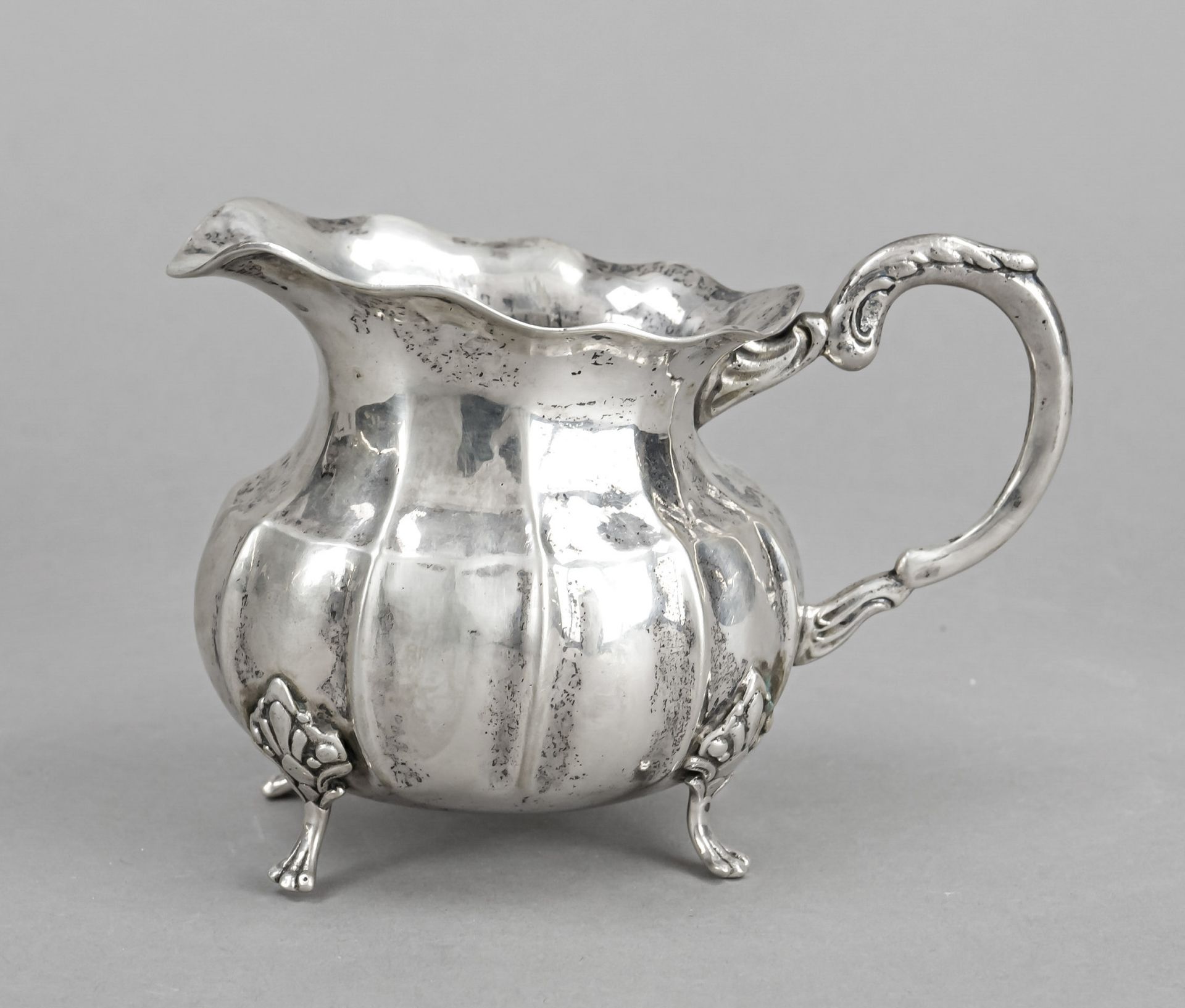 Cream jug, German, 20th century, silver 800/000, gilded interior, on 4 decorated feet, bulbous body,