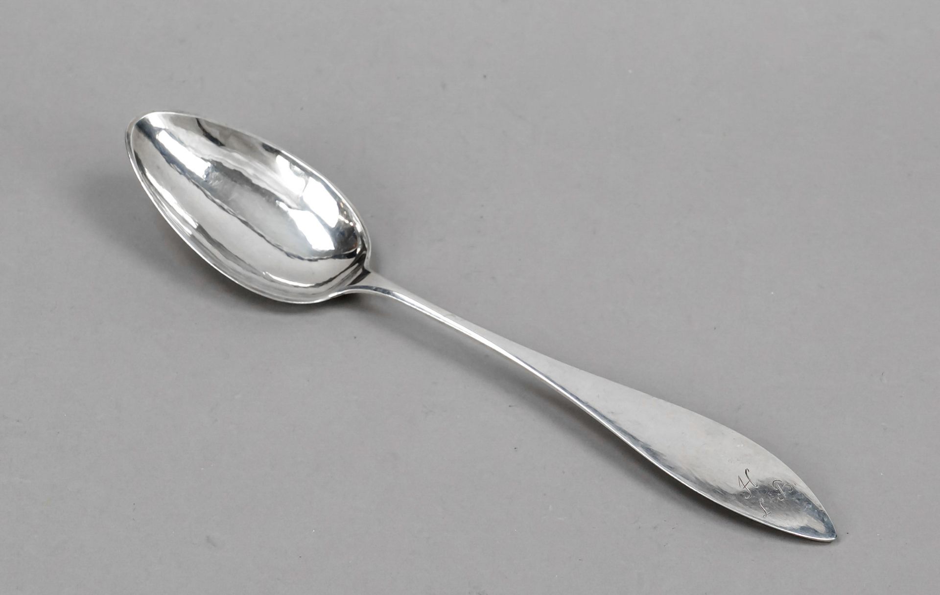 A large serving spoon, 19th century, hallmarked silver, tapered handle with monogram, l. 30 cm,