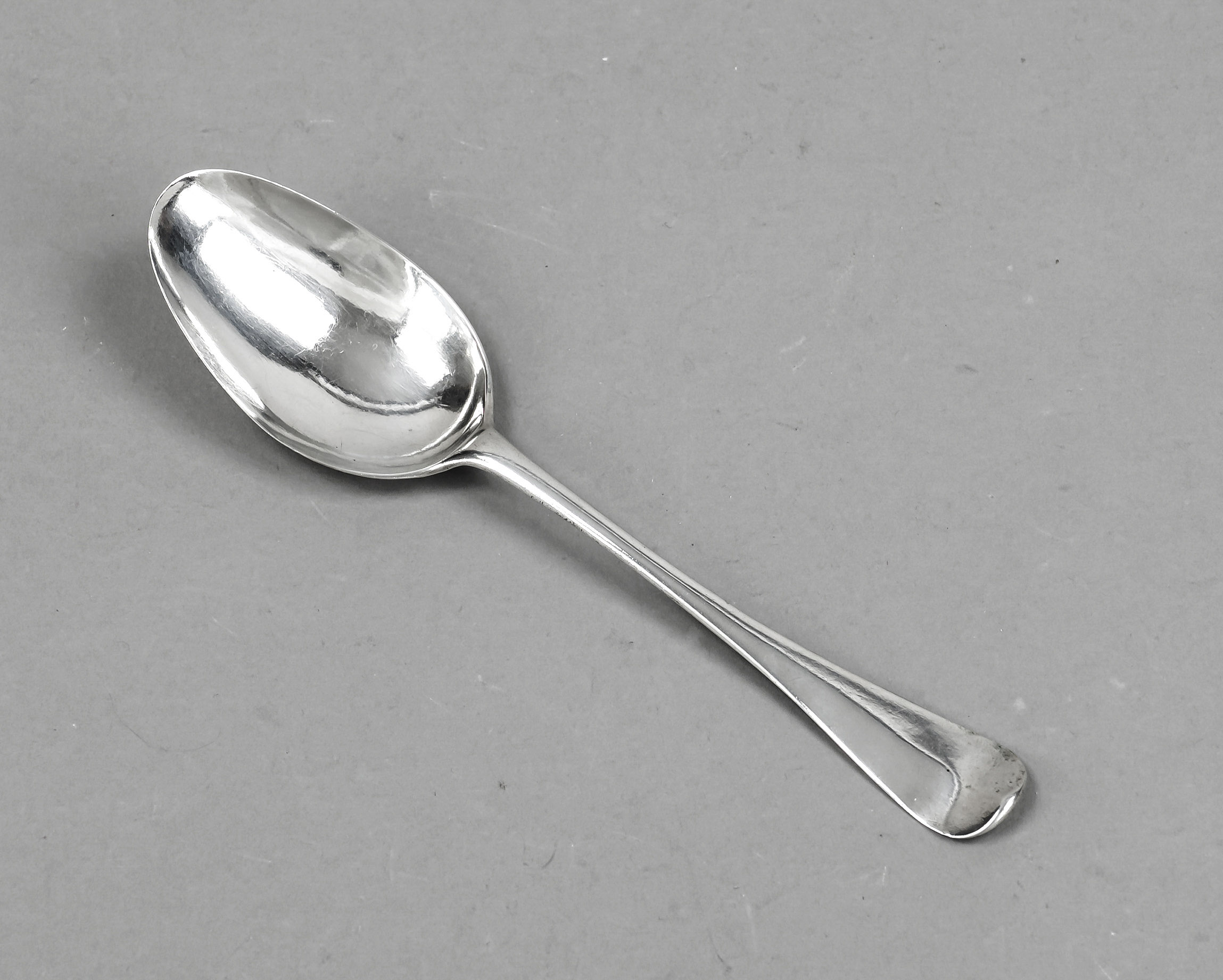 A serving spoon, probably German, mid 18th century, silver tested, oval bowl, rounded handle finial,