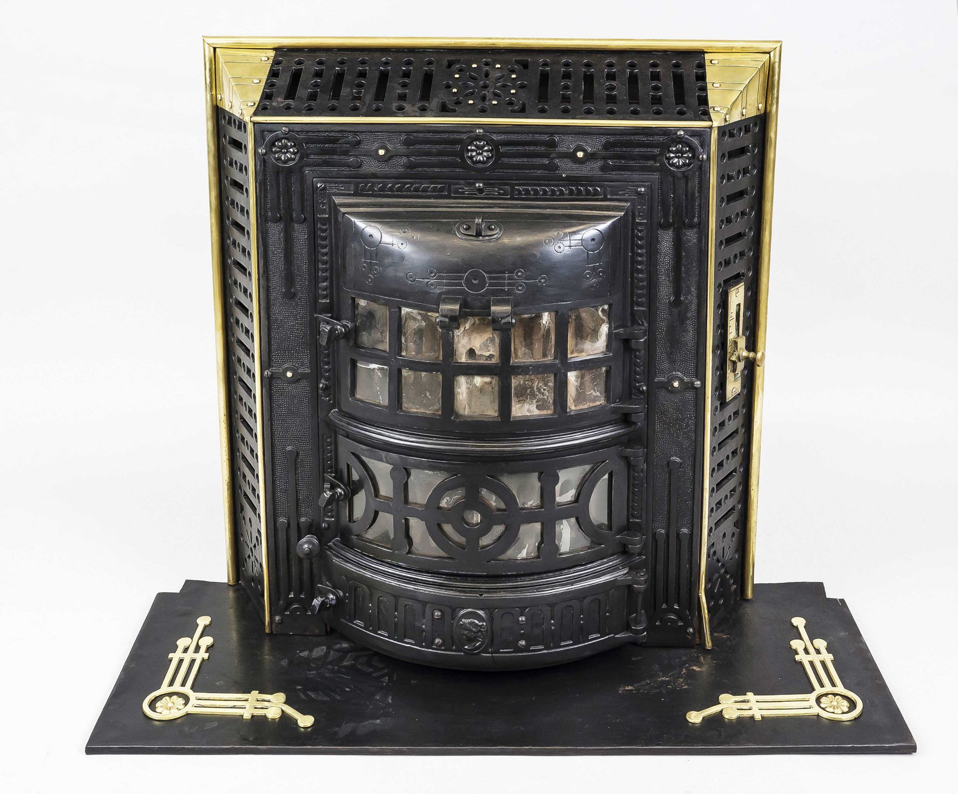 Art Nouveau stove, late 19th century, cast iron with brass decorative elements. Relief ornamented