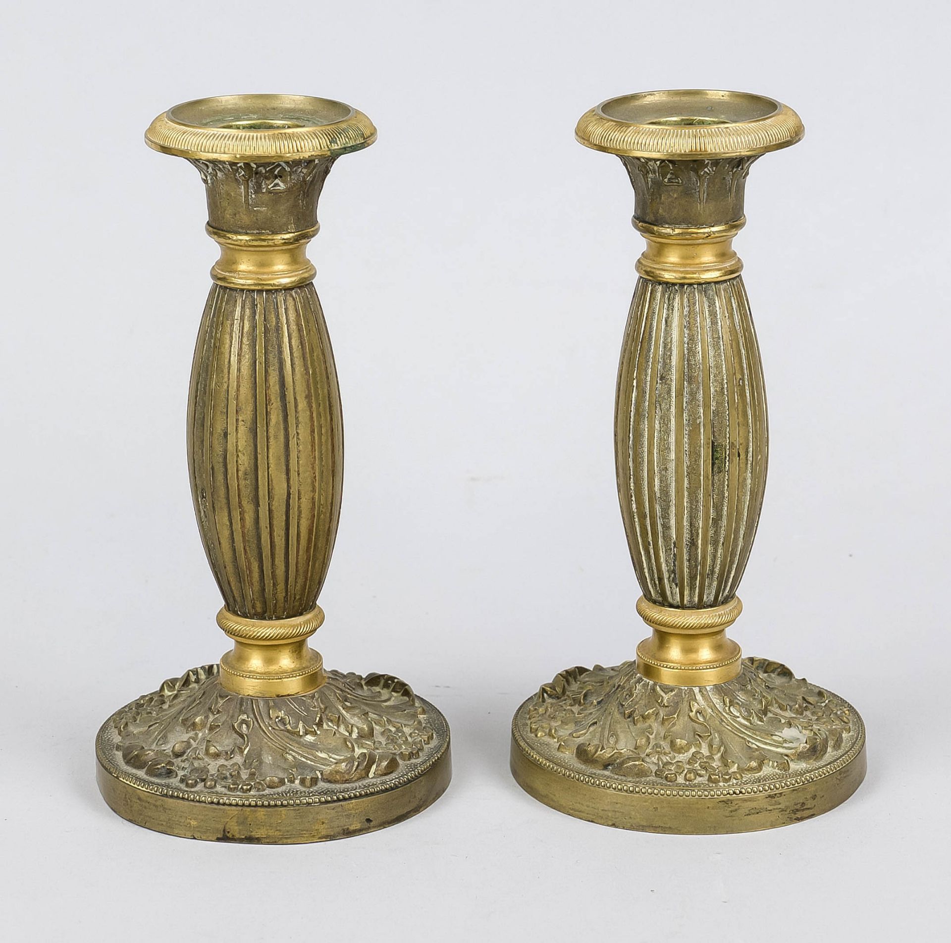 Pair of candlesticks, late 19th century, bronze/brass. Bulbous column shaft on ornamented foot, vase