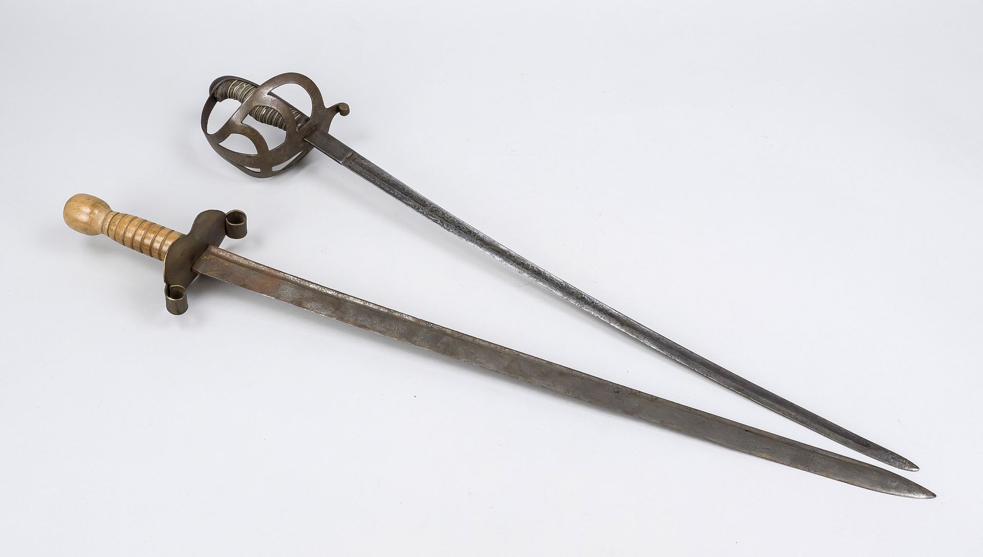 2 sabres, 19th century, iron and wood. A light version with iron basket, blade finely etched with