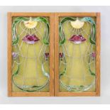 2 Art Nouveau leaded glass panels, c. 1900, symmetrically framed vegetal blossom illuminated by