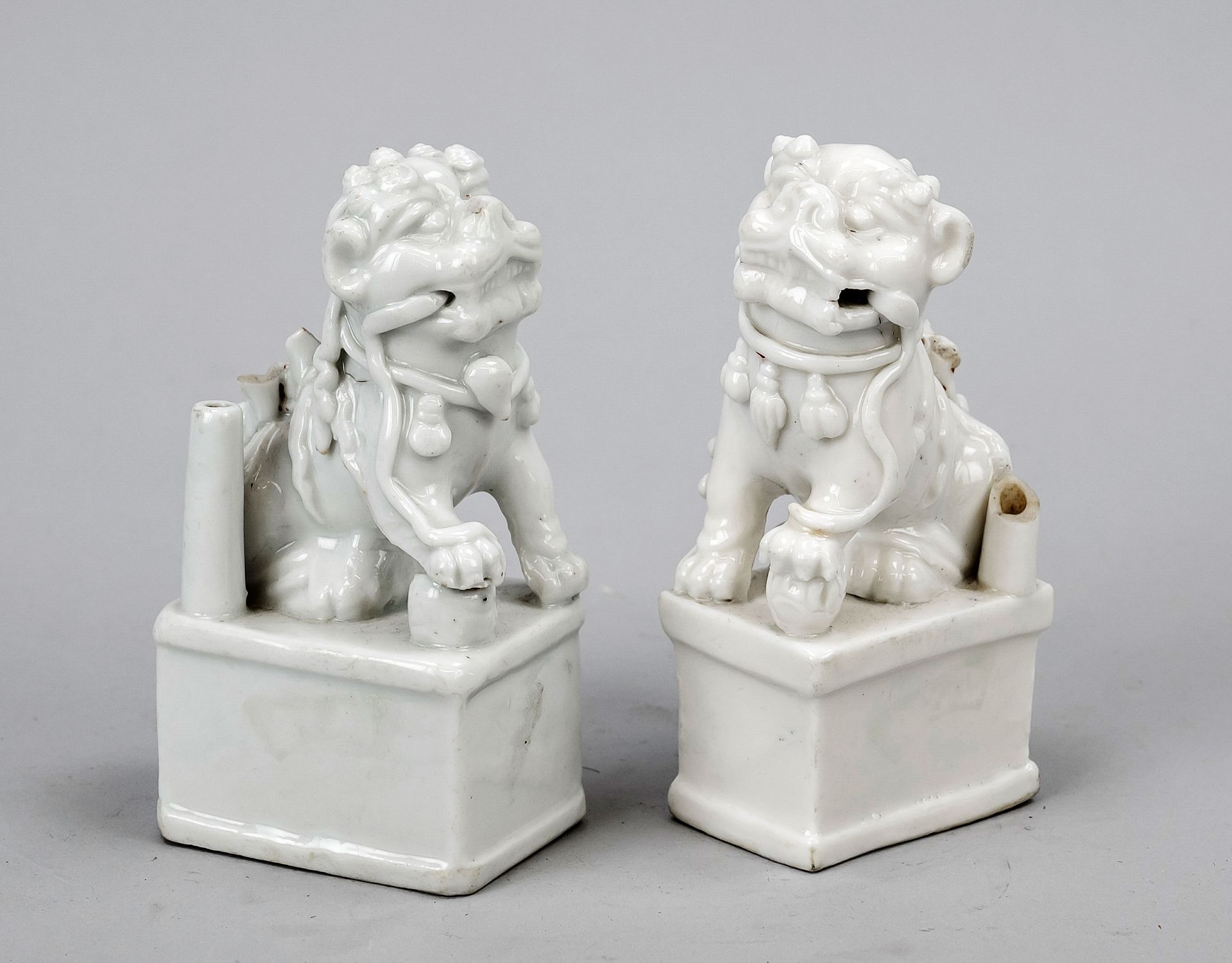 A pair of Blanc de Chine guardian figures, China (Dehua), probably 18th century, both heavily