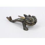 Table lighter, 2nd half 20th century, patinated brass. Sea monster or dragon on two front legs, a