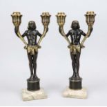 Pair of candlesticks, 20th century, bronze. Egyptian standing on a pedestal and holding a pair of