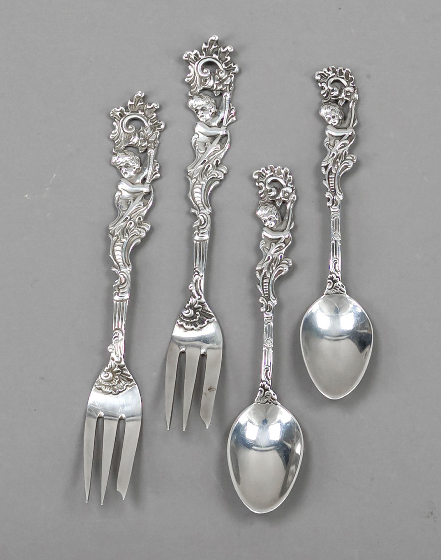 Twelve pieces of cutlery, German, 20th century, silver 800/000, handles with relief decoration,