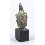 Buddha head/fragment, Southeast Asia, exact age uncertain, bronze. Mounted on a wooden base, h. 10