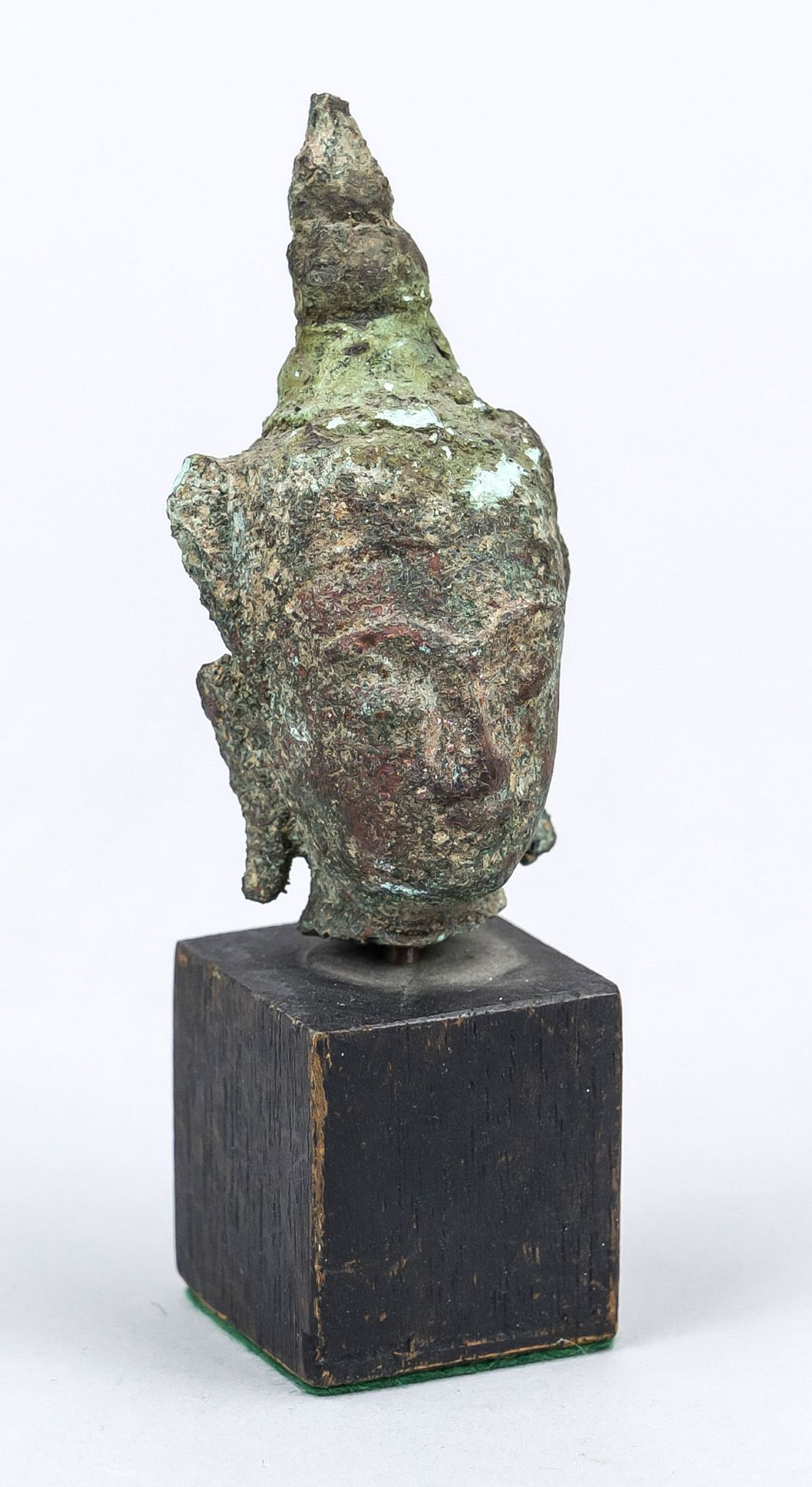 Buddha head/fragment, Southeast Asia, exact age uncertain, bronze. Mounted on a wooden base, h. 10