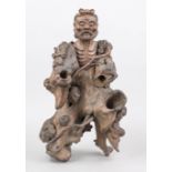 Figure of an ascetic, China, probably Republic period. Dark, gnarled burlwood, largely left