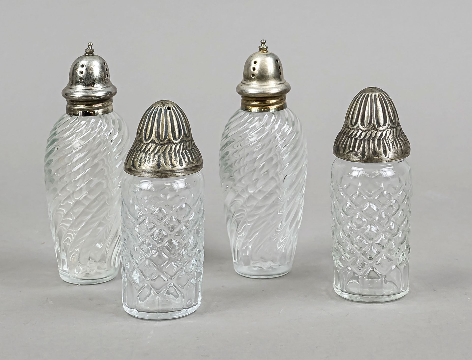 Two pairs of shakers, 20th century, molded glass body with metal lids, h. 11 and 13 cm respectively