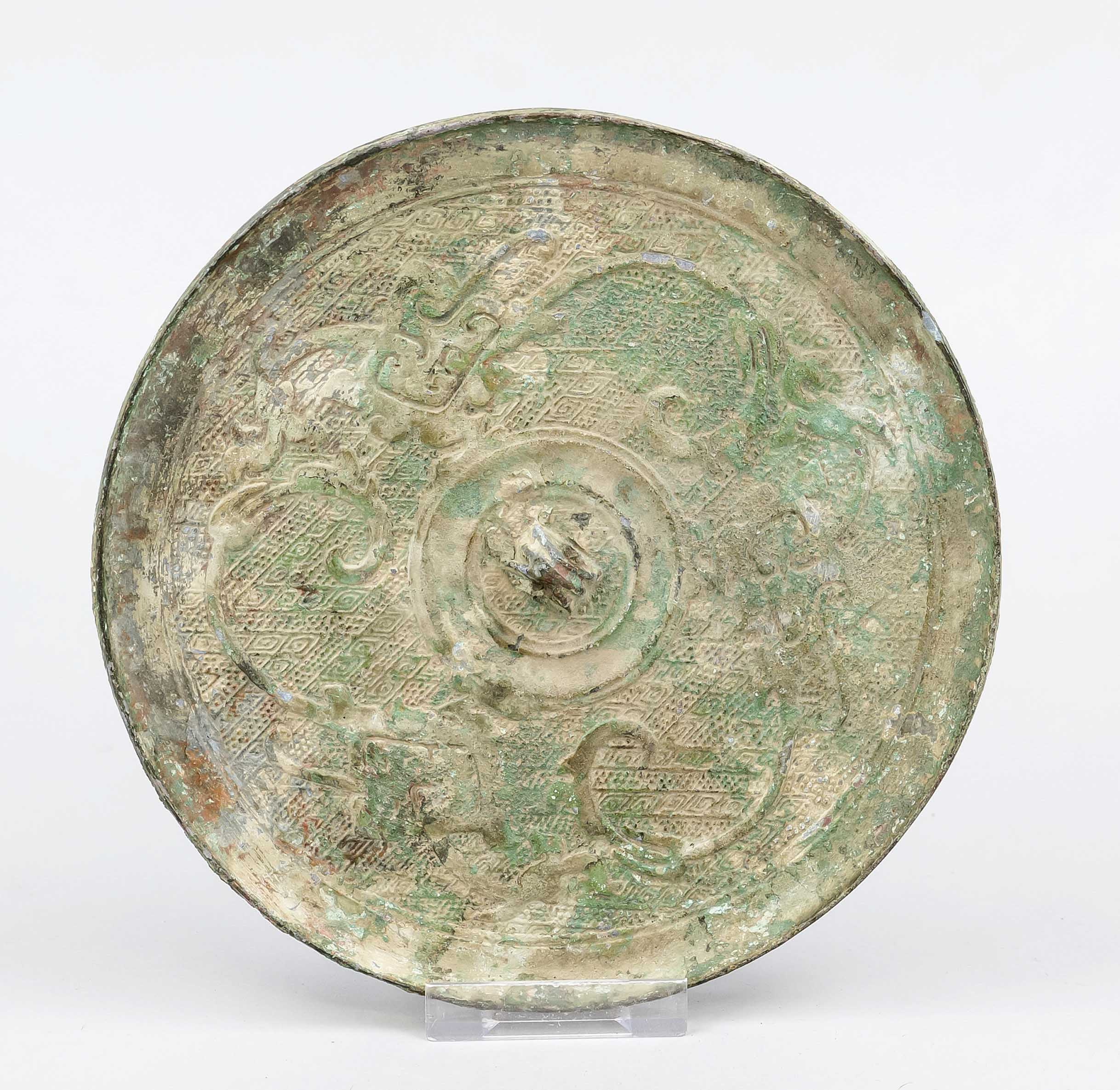 Large bronze mirror, China or Vietnam, exact age uncertain. Relief decoration, verdigris patina,