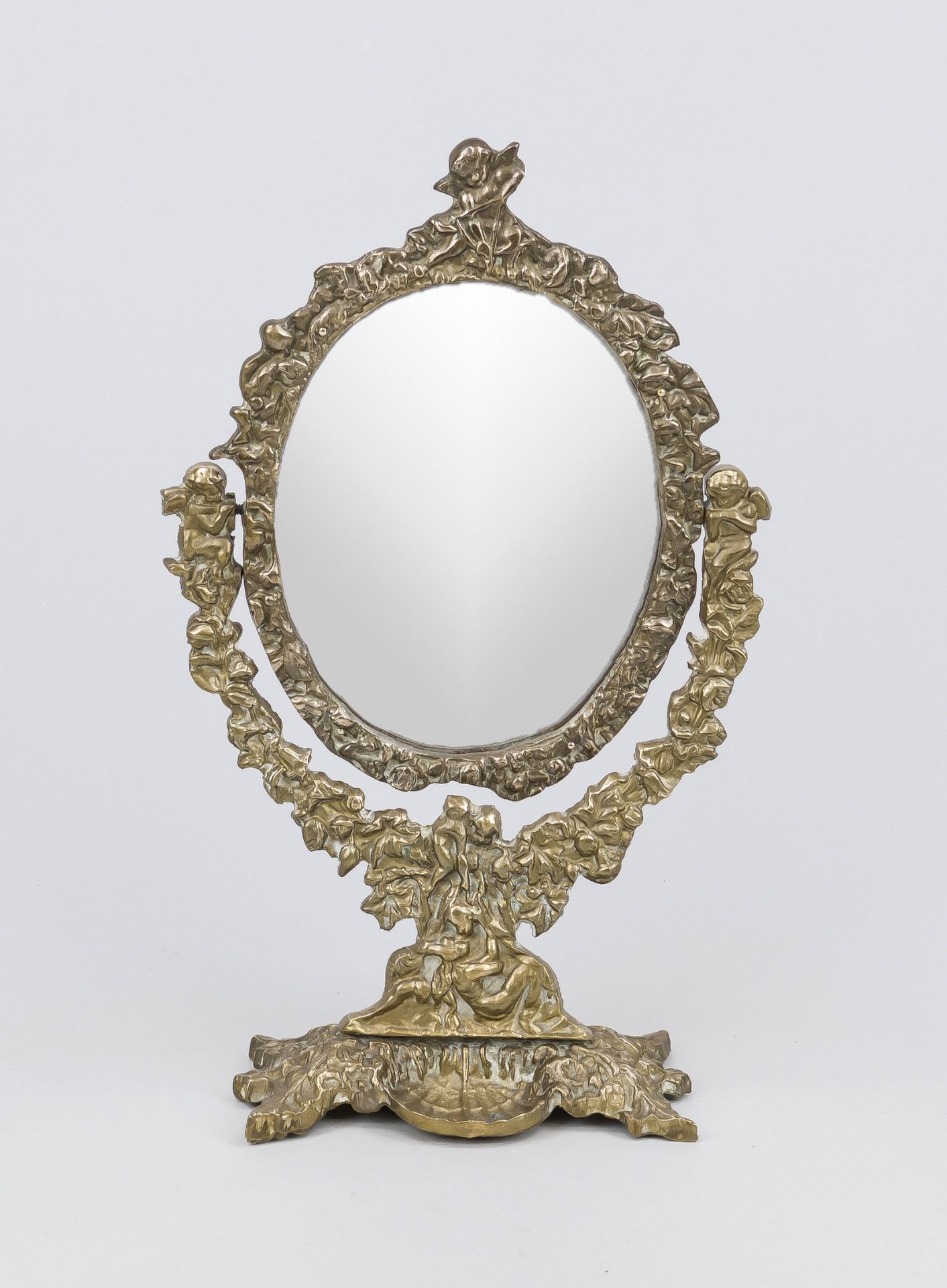 Table mirror, late 19th century, brass/bronze. Oval framed mirror glass (replaced) in ornamented