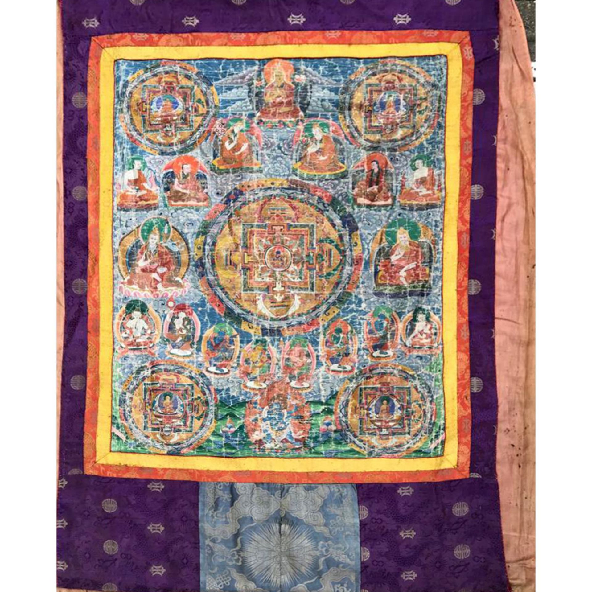 Thangka, Tibet 19th century, polychrome pigments and gold on cloth in a multicolored brocade