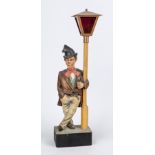 Tramp leaning against a lantern, 20th century, carved and painted wooden figure, mechanism with