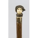 Walking stick with figural pommel, probably late 19th century, slender, natural shaft of dark