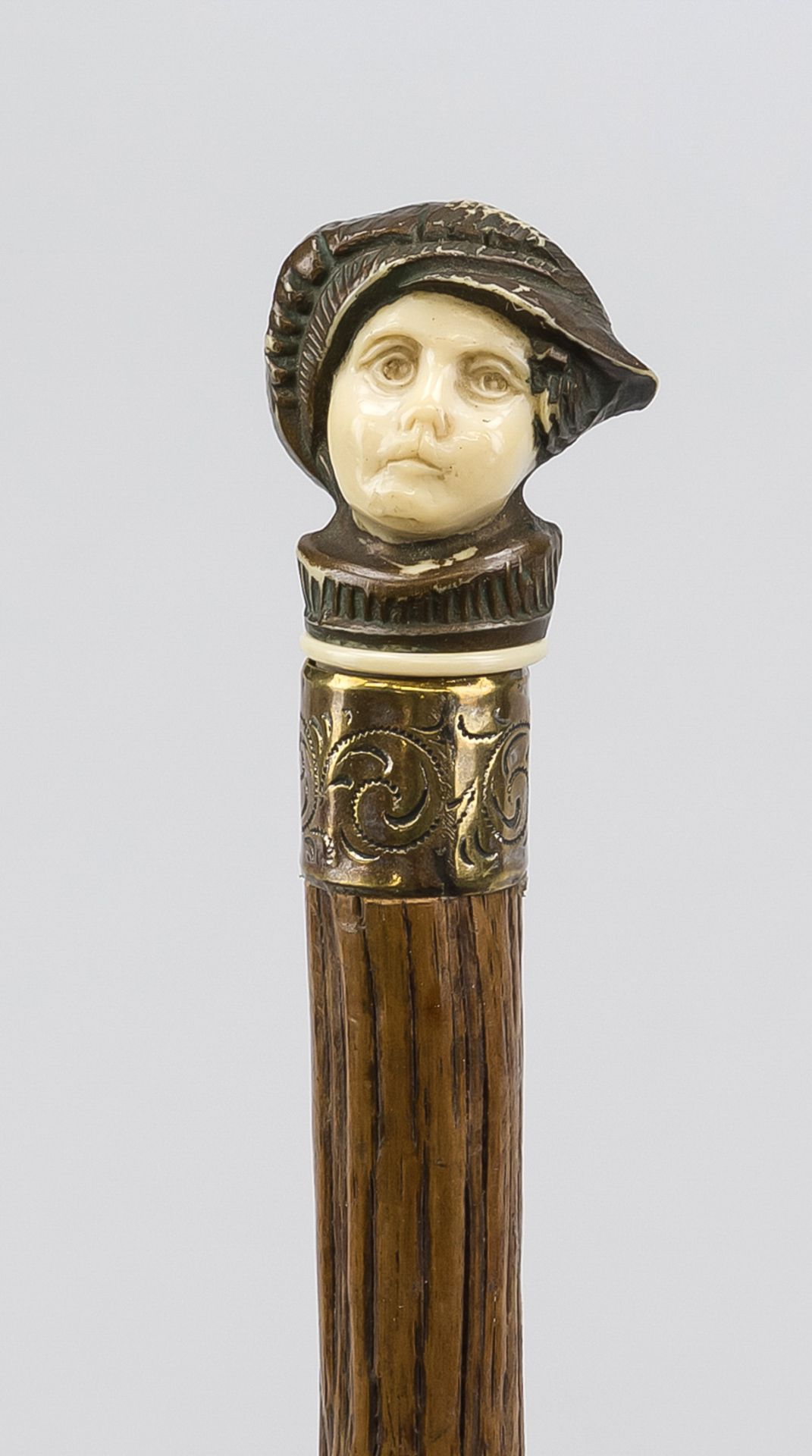 Walking stick with figural pommel, probably late 19th century, slender, natural shaft of dark