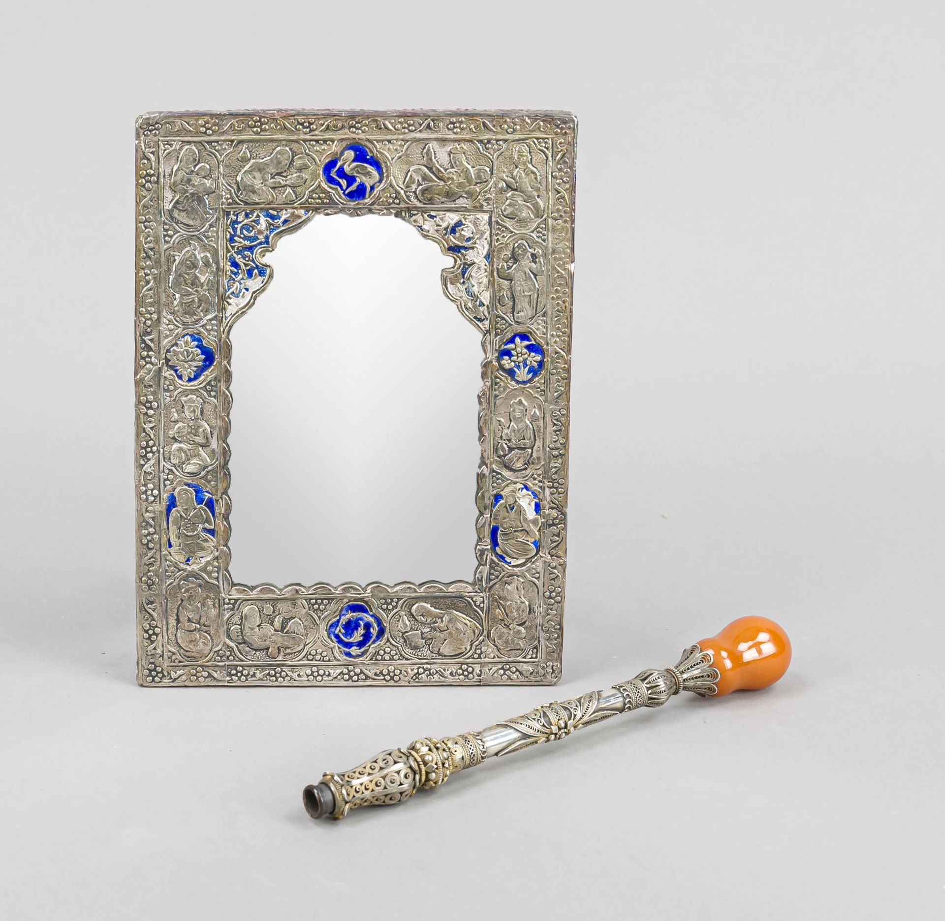 A small rectangular mirror, Oriental, silver tested, partly blue enameled (damaged), figural