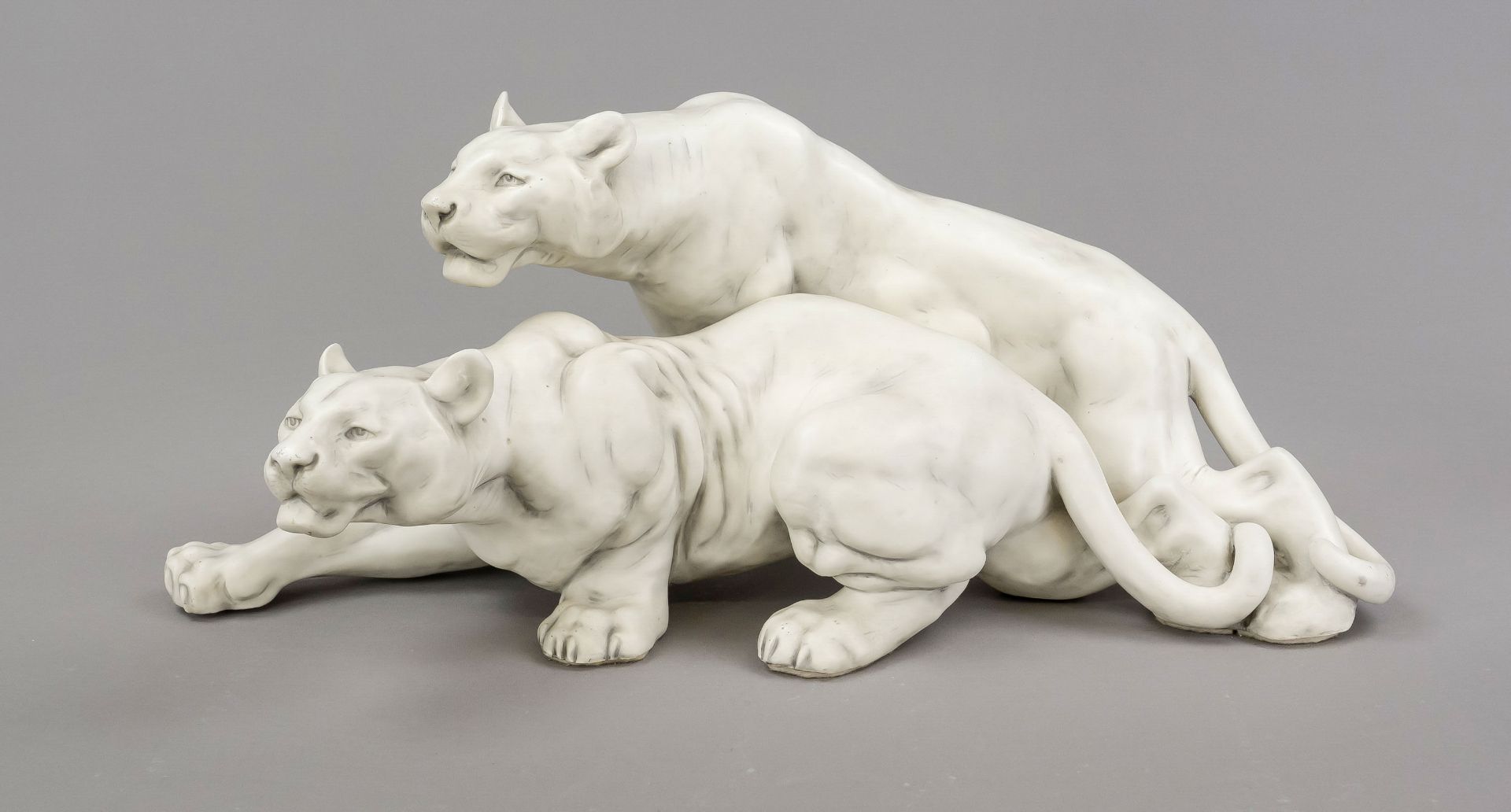 Large lion group, 20th century, masterly sculpture of two cats of prey in a creeping pose, white,