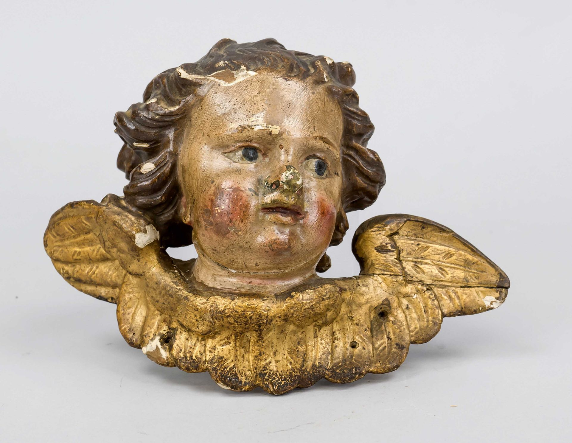 Angel's head or putti head, 19th century, carved wood and painted, gilded wing wreath, suspension on