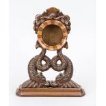 Pocket watch stand, c. 1900, hand-carved wood. A round container in which the clock is inserted is