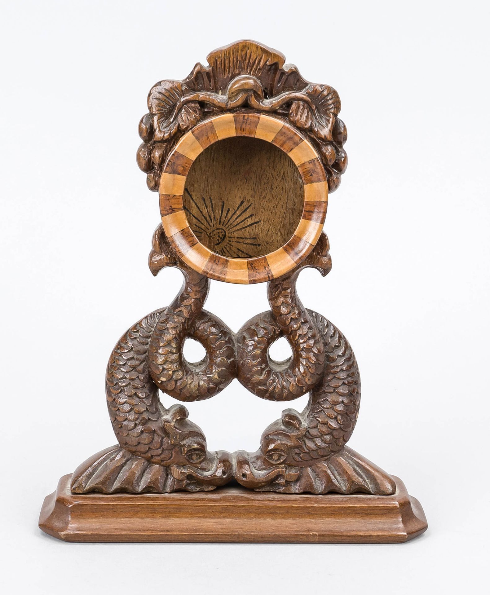 Pocket watch stand, c. 1900, hand-carved wood. A round container in which the clock is inserted is