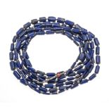 Very long endless lapis lazuli necklace made of barrel-shaped lapis lazuli elements 16 - 3 mm and