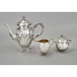 A three-piece coffee pot, German, c. 1900, silver 830/000, the interior partly gilt, each on 4 feet,