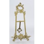 Small easel in historicism style, 20th century, brass with relief decoration typical of the style,