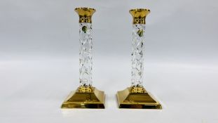 A PAIR OF WATERFORD CRYSTAL CANDLESTICKS HAVING SQUARE BRASS BASES AND RIMS (RETAINING ORIGINAL