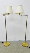 A PAIR OF BRASSED FLOOR STANDING LAMPS WITH ADJUSTABLE DOG LEG ACTION - SOLD AS SEEN.