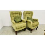 A PAIR OF SHERBORNE GREEN UPHOLSTERED WINGED EASY CHAIRS.