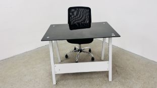 A MODERN DESIGNER HOME DESK WITH BLACK GLASS TOP ALONG WITH A MODERN ADJUSTABLE OFFICE CHAIR.