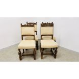 A SET OF FOUR OAK FRAMED DINING CHAIRS WITH CREAM UPHOLSTERED SEATS AND BACKS.