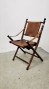 A REPRODUCTION FOLDING HARDWOOD CAMPAIGN STYLE CHAIR WITH TAN LEATHER SEAT AND BACK