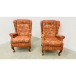A PAIR OF SHERBORNE RED PATTERN UPHOLSTERED WINGED EASY CHAIRS.