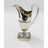 AN ANTIQUE SILVER HELMET SHAPED CREAM JUG, BIRMINGHAM ASSAY 1904 MAKER C.H. H 12CM.