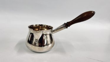 AN ANTIQUE SILVER BRANDY PAN WITH TURNED WOODEN HANDLE,