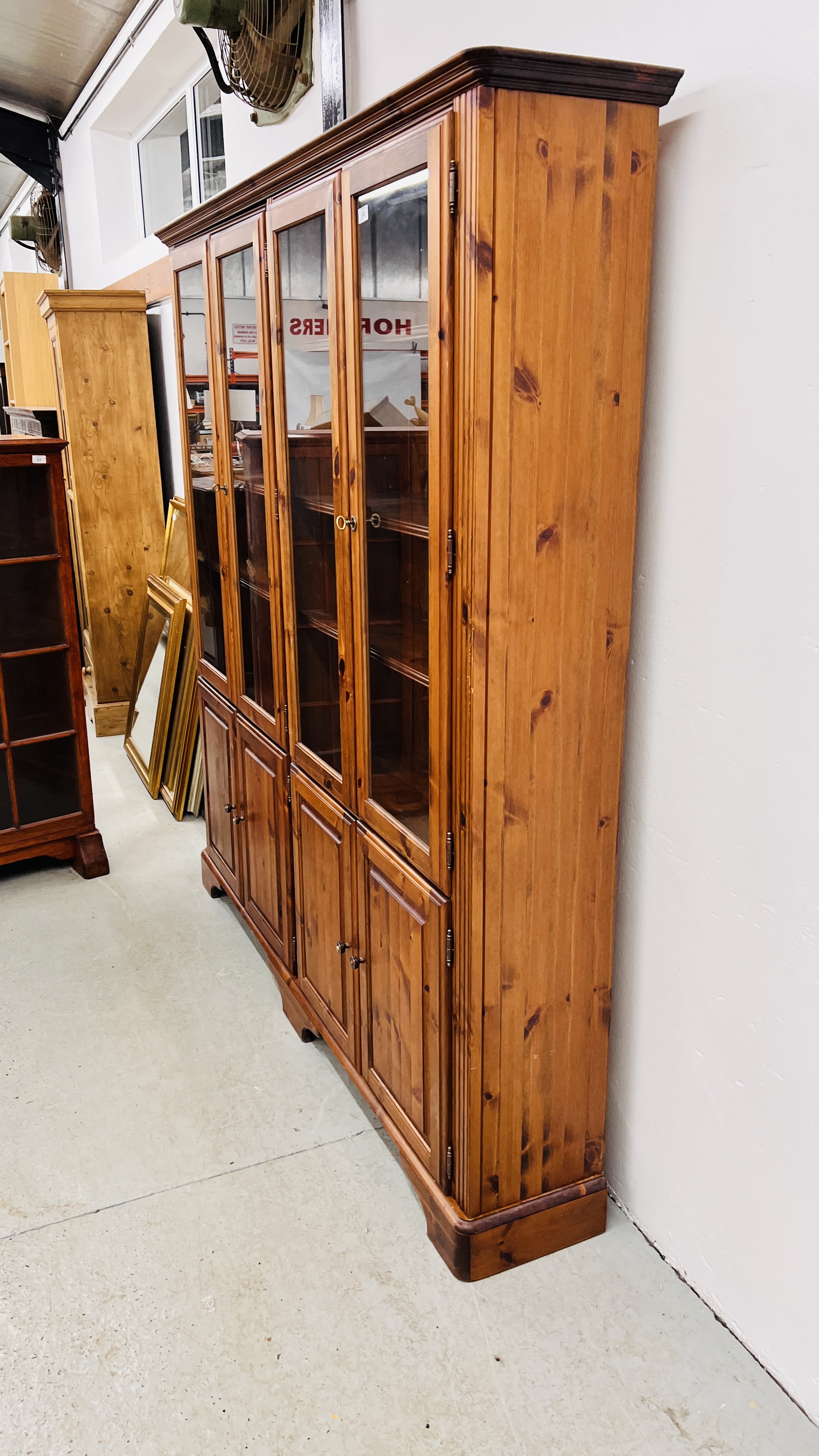 DUCAL HONEY PINE TRIPLE DOOR GLAZED TOP DISPLAY CABINET WITH CUPBOARD BASE. - Image 4 of 6