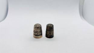 A SILVER THIMBLE, BIRMINGHAM ASSAY, PROBABLY 1923 MAKER J.F. ALONG WITH A BASE METAL EXAMPLE.