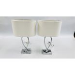 A PAIR OF DESIGNER CHROME BASED TABLE LAMPS WITH WHITE SHADES - SOLD AS SEEN.