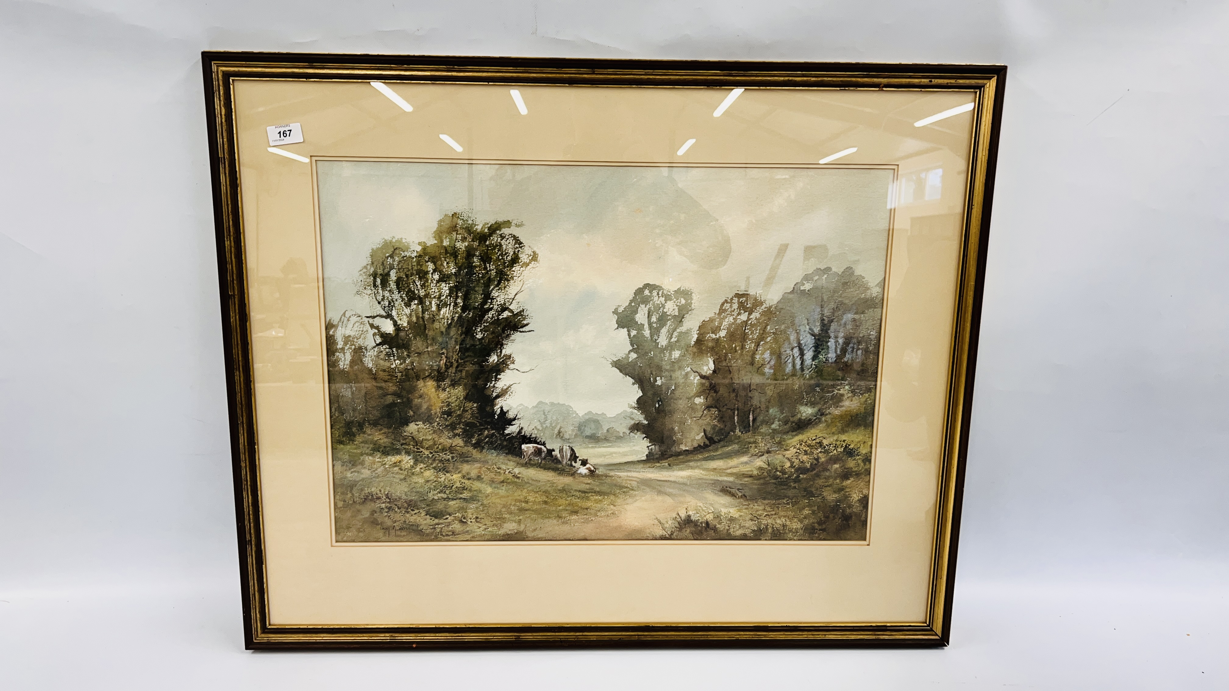 A FRAMED WATERCOLOUR "WENHASTON" DEPICTING GRAZING CATTLE BEARING SIGNATURE D.