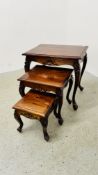 A NEST OF THREE GRADUATED GOOD QUALITY REPRODUCTION HARDWOOD OCCASIONAL TABLES.