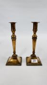 A PAIR OF ANTIQUE BRASS CANDLE STICKS - H 24CM.