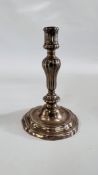 A CONTINENTAL CAST SILVER CANDLESTICK, THE GADROONED COLUMN ON A STEPPED AND SCROLLED BASE - 21.